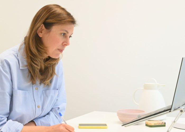 Julia am Laptop macht ein Selbstwerttraining mit der Klopftechnik PEP